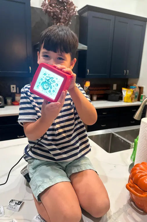 Child holding a KeepHi printer