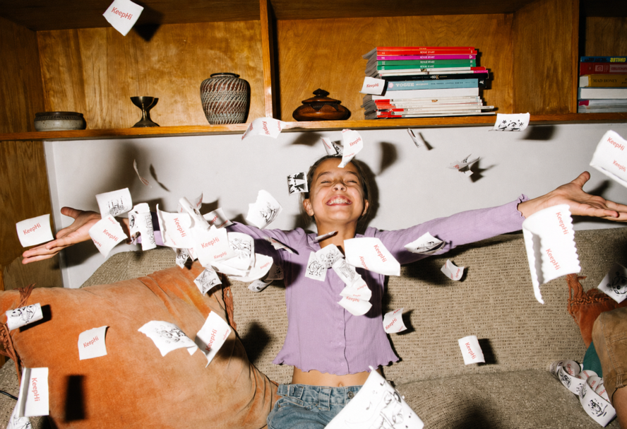 A child celebrating with printed stickers